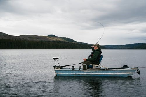 old man fishing in lake