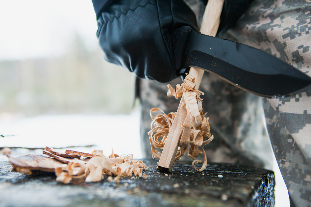Carving wood shavings with a knife blade
