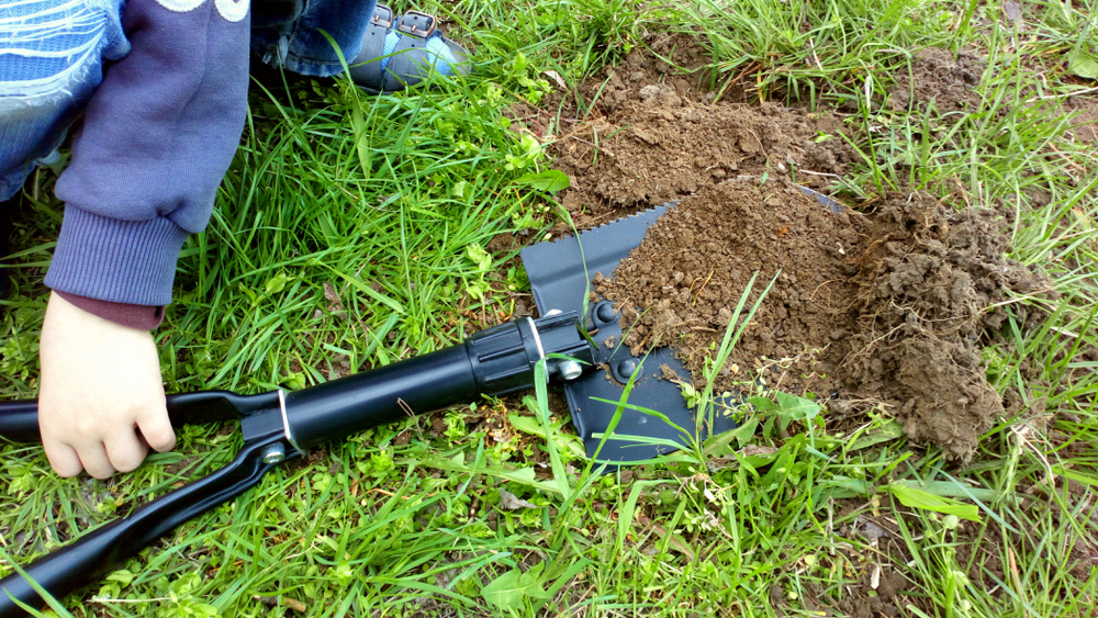 Digging with a tactical folding shovel