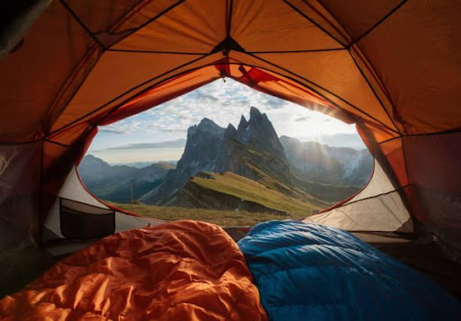 View of a Mountain from Inside a Tent with Sleeping Bags in Foreground