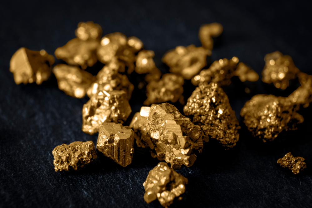 Collection of golden nuggets on black background